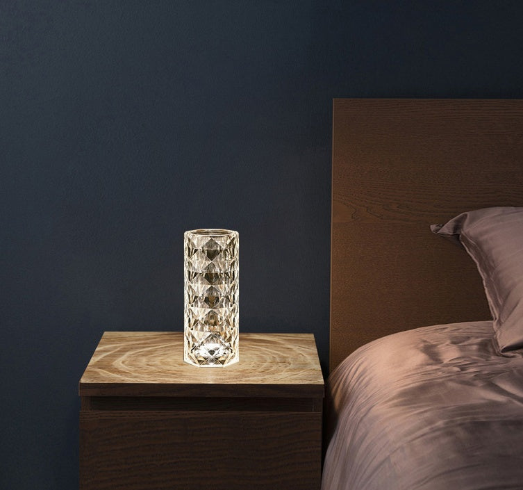 Decorative Two textured Crystal LED Touch Table on a wooden nightstand next to a bed with a dark wall background