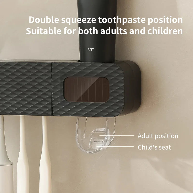 Black toothpaste dispenser with dual positions for adults and children, labeled on a neutral background.